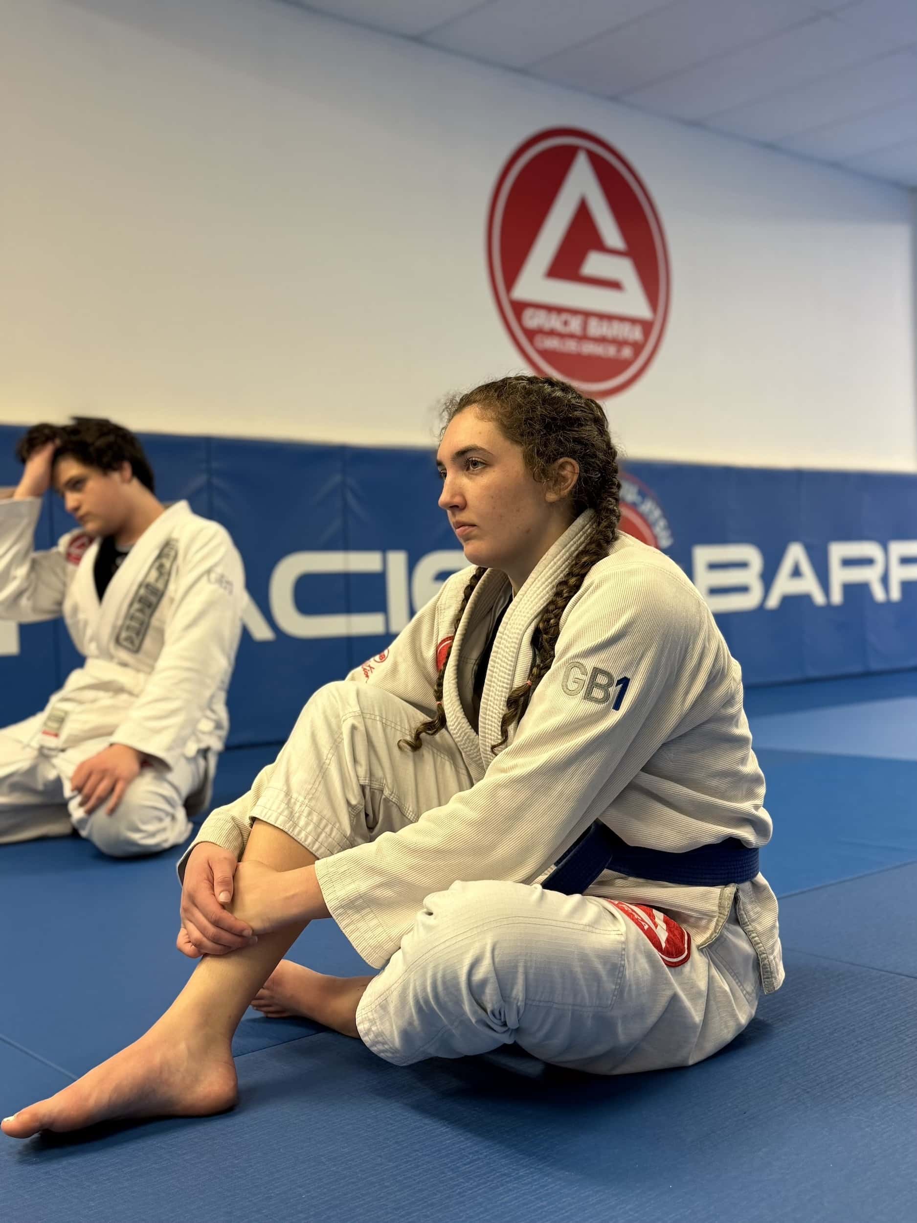 Gracie Barra Anniston student watches instructor give demonstration