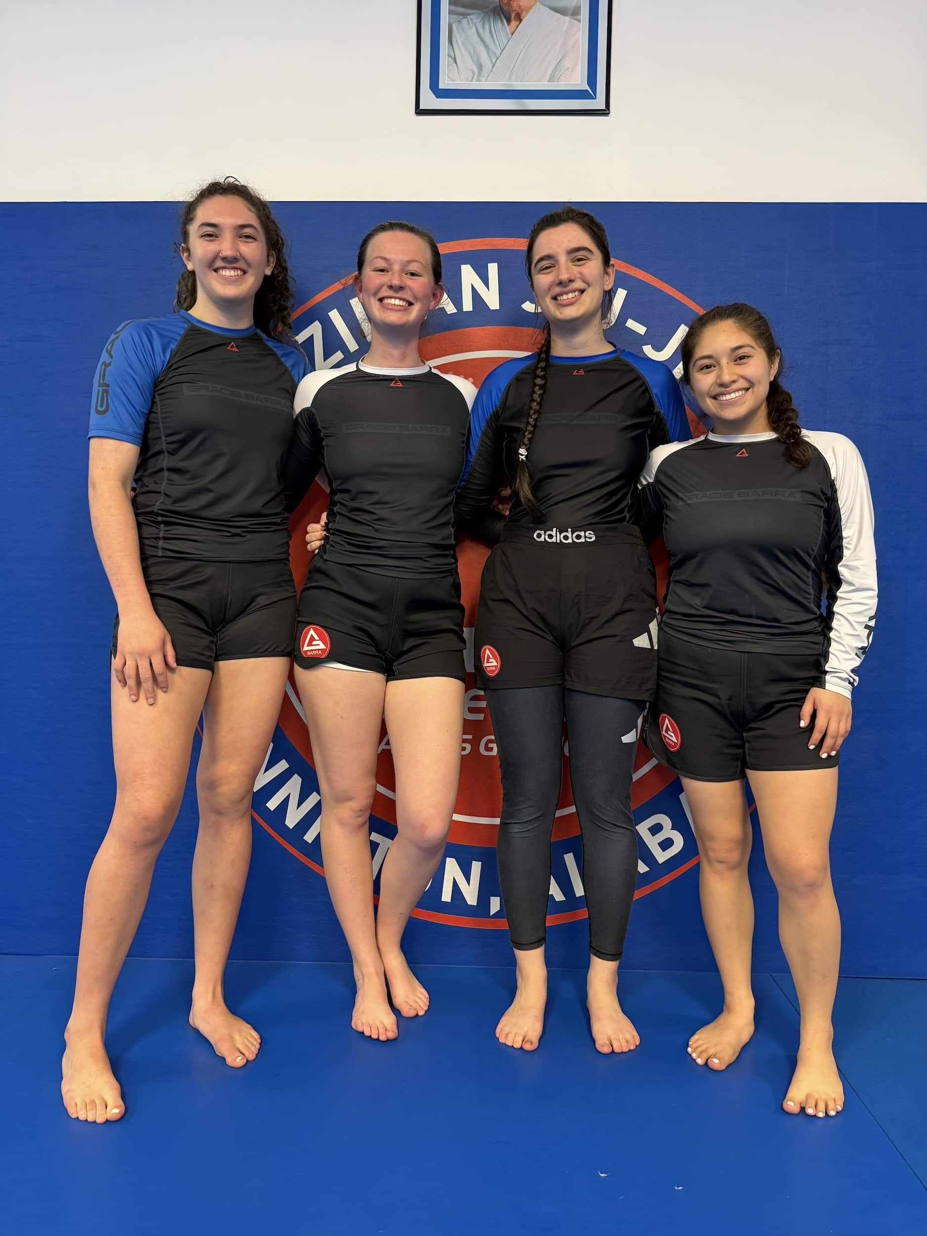female Gracie Barra Anniston students line up for picture after women's only class